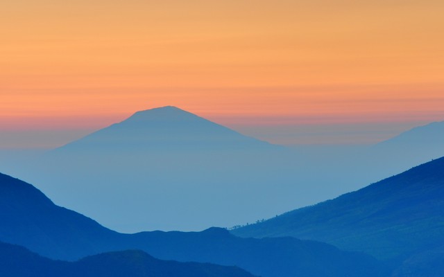 Layered mountains at sunset